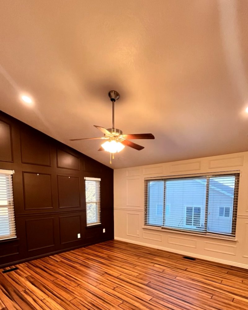 Ceiling fan and recessed lighting in a vaulted bedroom